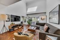 Natural light floods the 2 story living area from the skylights above