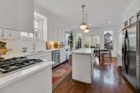 Kitchen with breakfast area, and freshly painted mahogany cabinets.