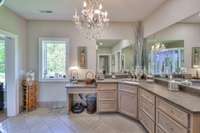 Large primary bath with lots of storage. Crystal chandelier does not remain.