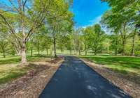 Privacy at its finest!! 1800 Linear feet of paved driveway leading to the home.