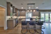 Custom made cabinetry with quartzite countertops. 40" Gas Range.