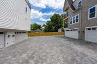 Courtyard Paved Driveway to private garages of Units A,B,C,D. Complete with 3 side privacy fence around the property.