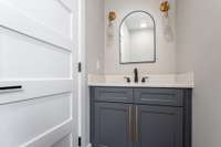 Powder Room with Quartz Counter Top and upgraded lighting and accent features.