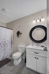 GUEST BATHROOM TUB AND SHOWER COMBO TILE FLOOR