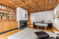 Custom built in bookshelves and cabinets flank either side of the fireplace, providing functionality and a beautiful backdrop.