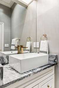 Each of the updated ensuite baths features sleek modern updates.