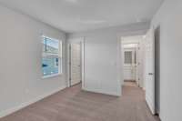 One of three secondary bedrooms upstairs, all with large walk-in closets.