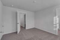 One of three secondary bedrooms upstairs, all with large walk-in closets.