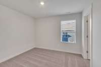 One of three secondary bedrooms upstairs, all with large walk-in closets.