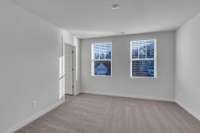 One of three secondary bedrooms upstairs, all with large walk-in closets.