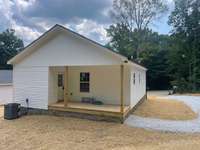 Covered back porch with door leading into the laundry area