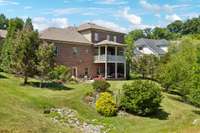 Play catch in the Yard and continue the vegetable garden between the home and treed area behind.