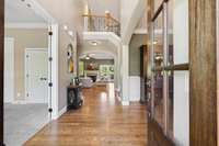 Upon entering you will notice iron railings and a beautiful double, 6-light, arched wood door.