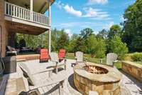 A Covered Patio below offers more seating and the Uncovered Patio features a flagstone seating wall surrounding a fire pit.