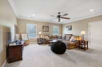 Found at the top of the hardwood stairs overlooking the Foyer, the Bonus Room offers plush carpet, recessed lighting, a ceiling fan, & access to a partially finished attic (as well as an unfinished attic space).