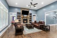 Beautiful living room with lots of natural light, stone fireplace with gas logs and space galore.