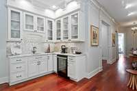 A closer view of this updated beverage center with glass front cabinets, unique tilework and new beverage frigde...