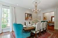 This spacious formal dining room hosts beautiful moldings, lots of natural light and gorgeous crystal chandellier...