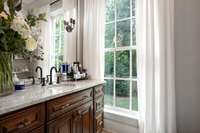 This secondary water closet & vanity is larger than it appears, plus a linen closet hidden in here as well...