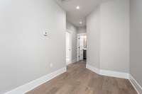 Hallway of 3rd Level leading to Guest Bedroom and Hallway Bath, Laundry Room and Primary Bedroom.