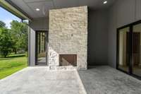 Gas fireplace with stone, see also the direct access to the patio from the primary suite