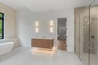 Primary Suite bath with clean, large format tile and dual vanities. Mirrors to be selected.