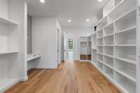 Make-up counter in the closet with quartz countertop. Buyer to select mirror.