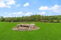 The perfectly placed stones are the best place to relax and take in all the sounds of nature.  Your very own Zen Garden.    *The grass color is enhanced*  The owner has planted new grass, It is growing in nicely but not fully in.