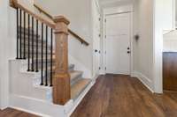 Stair way to the Enormous additional room just off the kitchen. Access door direct to your Double Car Garage.