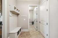 The mudroom is located just off the garage. The laundry, with a sink, is just beside it.