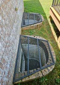 Basement window bays are covered with custom made protectors, while still letting light into the basement area.