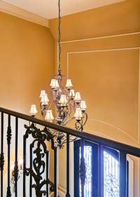 View of foyer chandelier from upstairs. Operates on a winch for easy cleaning.