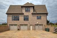 Huge three car garage with workshop area and Elevator inside. One of the garage doors was dented, so all three doors are being replaced with matching new ones.