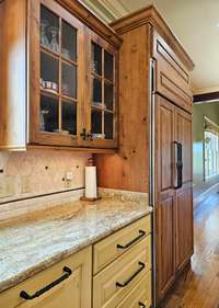 Granite countertops, tiled back spashes, and a Sub-Zero refrigerator beautifully paneled with custom cabinetry..