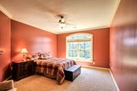 Upstairs guest bedroom with double arched window. Each bedroom has it's own full bath.