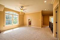 Large upstairs common area features an arched double window and play closet.