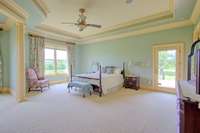 Huge Primary bedroom suite with double tray ceiling, overhead recessed lighting and access to  private deck.