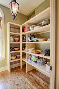 Fantastic pantry off of kitchen with arched window offers extra room for food and large serving dishes as well as small appliances. This is only one view of this oversized pantry.