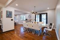 Dining, living, & kitchen all flow nicely together for entertaining and family/friends time. Bold white and black contrast throughout house