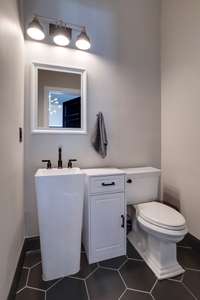 Tiled half bath attached to the den