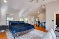 Upstairs / 2nd primary bedroom, windows in view look over the back lawn & deck area