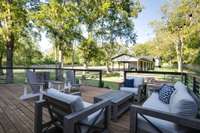 Large contemporary deck, view of carport and recording studio building in the rear