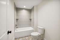 Full bath upstairs with double vanity and separate toilet/tub area