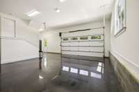 Oversized garage with storage area and epoxy floors