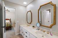 Jack/Jill has large double vanities and separate toilet area with shower/tub combo.