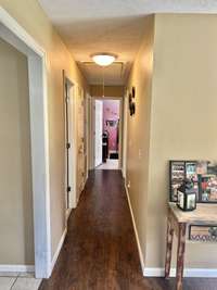 Looking down the hallway to the three bedrooms and two full bathrooms