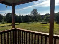 View from the Back Covered Deck to Back Yard and More Fruit Trees