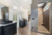 There is a large walk in custom tile shower and two large walk in closets at each end of this bathroom.