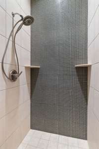 Floor to ceiling tiled shower.