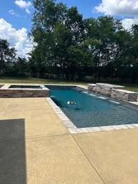 Another view of the pool.  Notice the privacy of the tree-line in the background.  It even has a tanning deck in the shallow end!